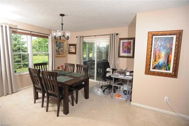 The dining room is adjacent to the living room and connects with the screened porch via a sliding door.