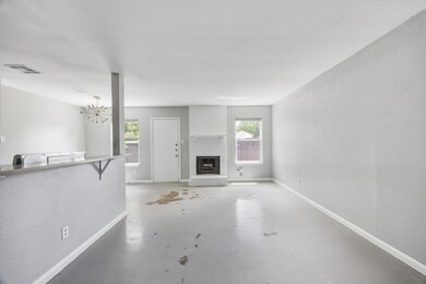 Unfurnished living room featuring concrete floori