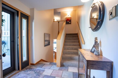 Entryway featuring stairs and baseboards