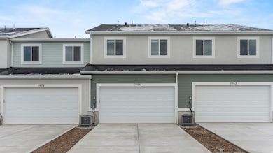 Traditional home with concrete driveway, a garage, and a shingled roof