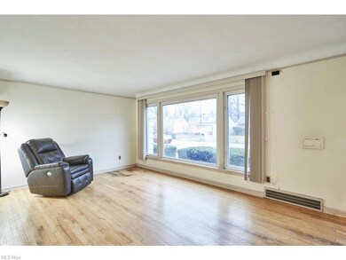 Living room with hardwood floors and a large windo