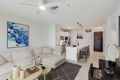Living room with ornamental molding, arched walkways, ceiling fan, and recessed lighting