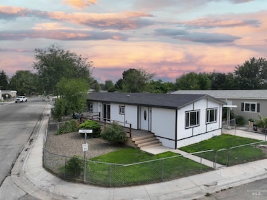 View of front of house with a fenced front yard, a shingled roof, and a gate
