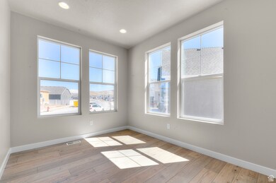 Spare room with light wood finished floors and recessed lighting