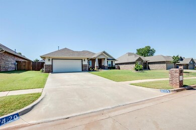 Single story home featuring a front yard and a garage