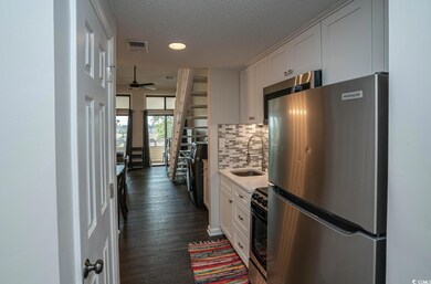 Kitchen with dark hardwood / wood-style floors, st