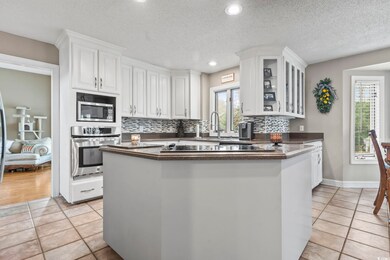 Kitchen featuring light tile patterned floors, whi