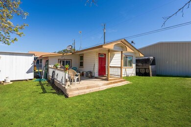 Rear view of property with an outbuilding and a y