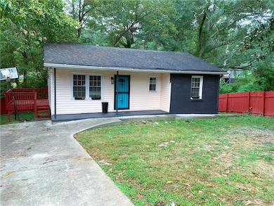 Bungalow-style home with covered porch, brick siding, and roof with shingles