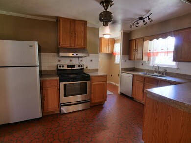 Kitchen featuring white appliances, rail lighting,