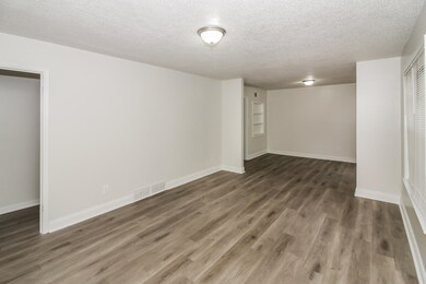 Spare room with a textured ceiling and wood finished floors