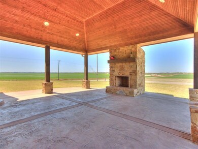 View of patio with an outdoor stone fireplace