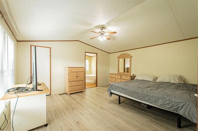 Bedroom featuring light wood-style floors, lofted