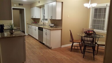 Warm granite and timeless back splash tile make th