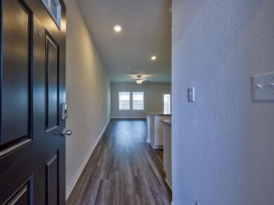 Corridor featuring dark wood-style flooring, base