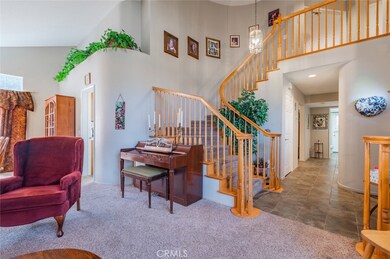 View of the grand staircase from the Formal Living Room.  Down the hallway is the downstairs bedroom, full bath, laundry room with a sink and direct access to the garage.