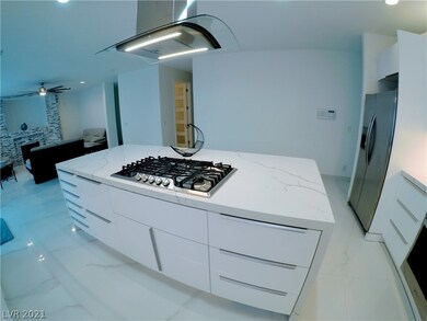 Huge kitchen island with cooktop and mounted range