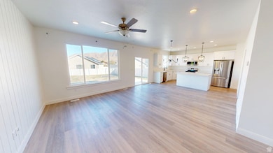 Unfurnished living room with light wood finished floors, recessed lighting, and ceiling fan