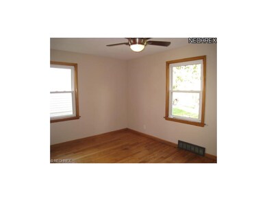 Bedroom 2 with hardwood floors.
