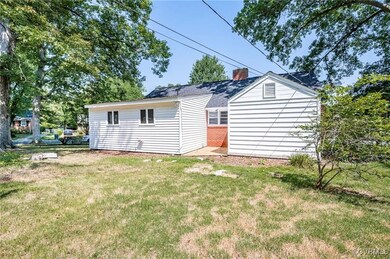 Rear view of property featuring a yard