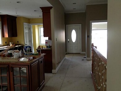 Foyer 10 foot ceilings in entry with open stairway