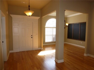 Entry way and formal dining. Beautiful wood floors, crown molding and custom framed chalk board.