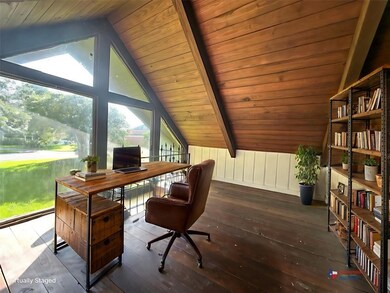This photo showcases a bright, airy loft space wit