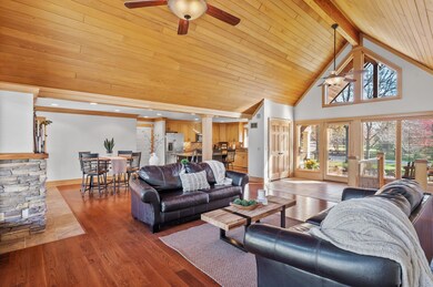 As you step inside, natural light fills the living room, thanks to its impressive 16-foot vaulted tongue and groove ceilings.