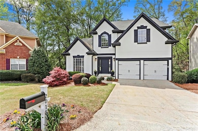 View of front of property with stucco siding, driv