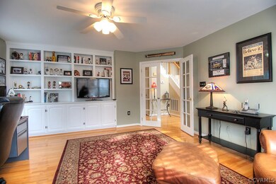 Living room with built-in cabinets, hardwood floor