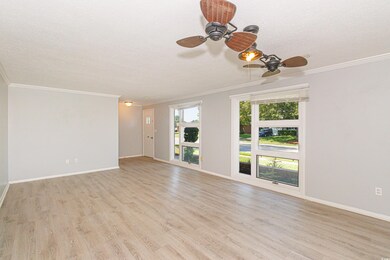 Unfurnished living room featuring ornamental moldi