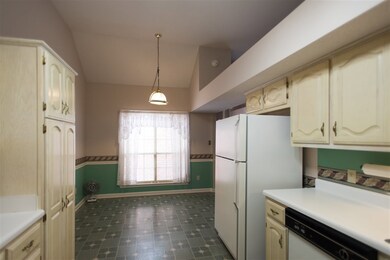 Large galley kitchen with plenty of light, cabinet