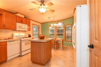 THE KITCHEN FEATURES LOADS OF CABINETS AND PANTRY 