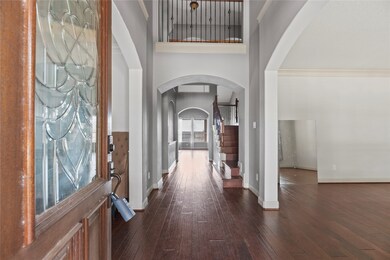 Front entry with a leaded glass door, wood floors