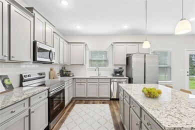 Kitchen featuring pendant lighting, sink, dark woo