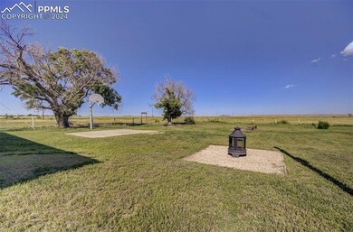 View of yard with a rural view and basketball cour