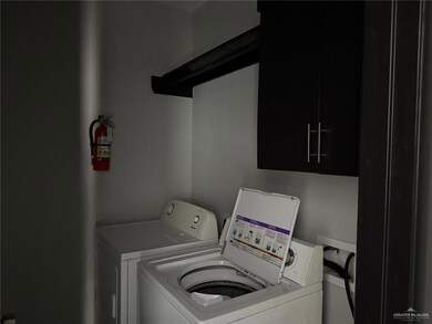 Washroom featuring cabinet space and washing machine and clothes dryer