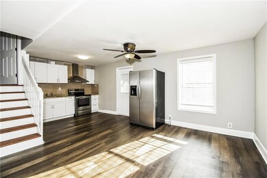 Kitchen featuring decorative backsplash, dark wood