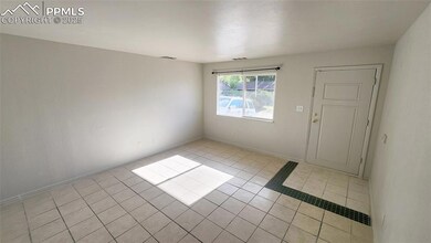 Spare room with light tile patterned flooring and baseboards