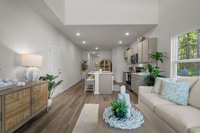 Living area featuring dark wood finished floors and recessed lighting