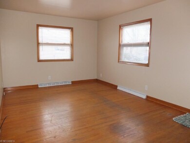 Spacious living room with hardwood flooring.