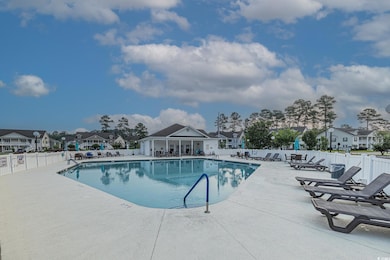 Community pool featuring a patio and a residential view