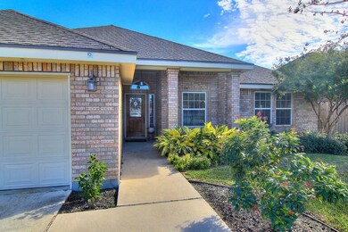This neat brick home and pretty landscaping shout