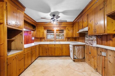 Kitchen featuring light countertops, brown cabinet