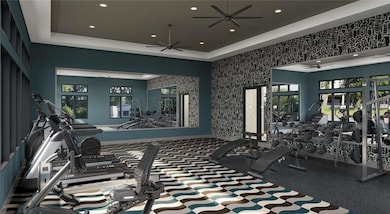 Gym featuring ceiling fan, a raised ceiling, and recessed lighting