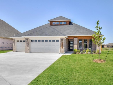 View of front of home featuring roof with shingles, brick siding, a garage, a front lawn, and concrete driveway