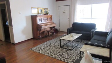 Living room featuring hardwood floors and natural