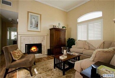 View of living room with fireplace & crown molding
