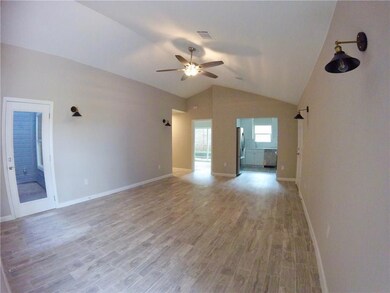 Unfurnished living room with ceiling fan, lofted 