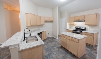 Kitchen with a sink, stainless steel appliances, l